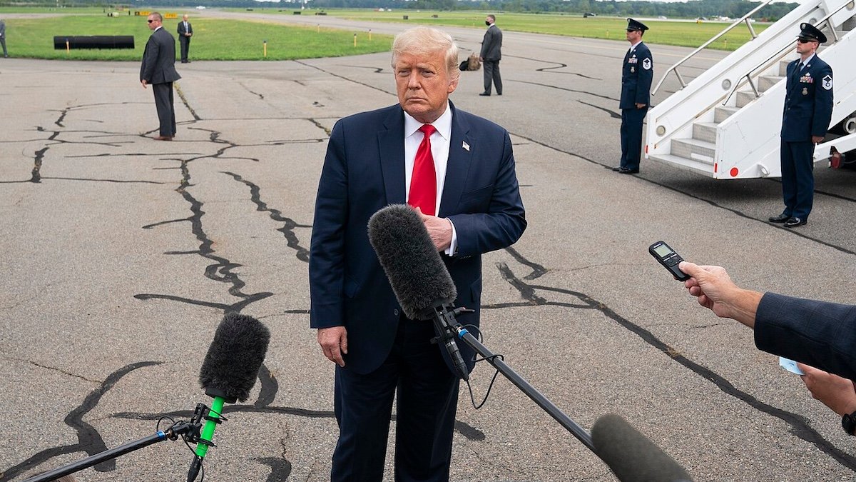 Donald Trump standing in front of the press